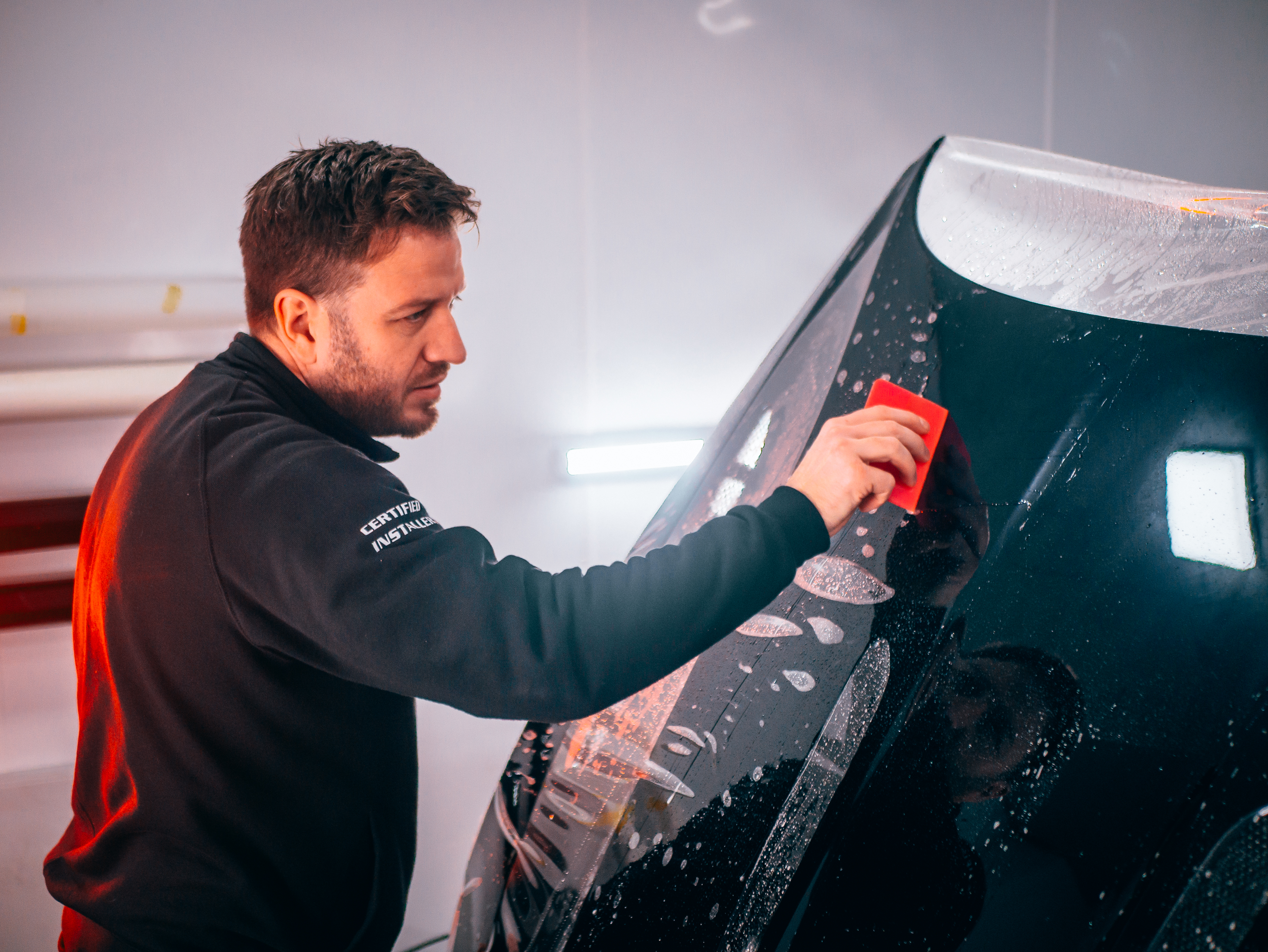 Lee Egan applying BodyFence PPF film in the studio